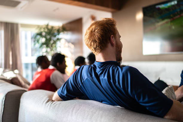 Sports friends fans watching a match at home